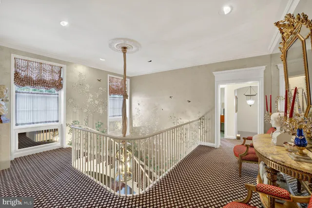 a view of a hallway with wooden floor and windows