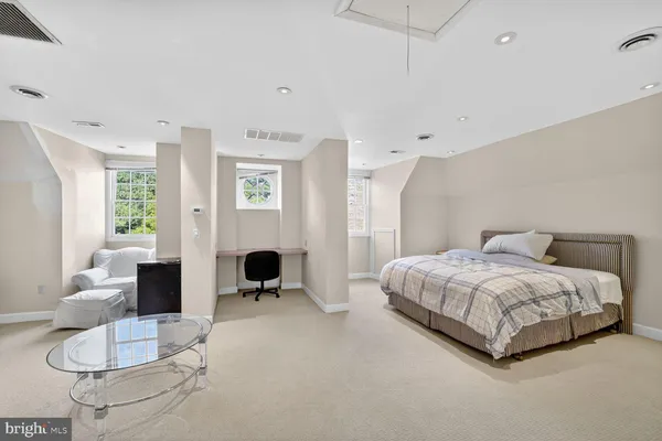 a spacious bedroom with a bed and furniture
