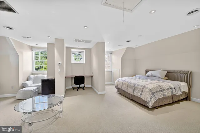 a spacious bedroom with a bed and furniture