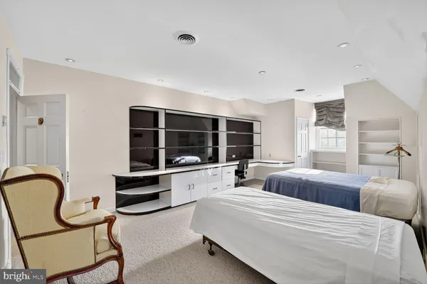 a large room with bed and windows