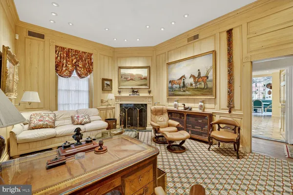 a living room with furniture a rug and a fireplace