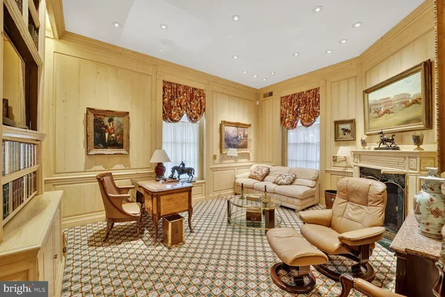 a living room with furniture and floor to ceiling window