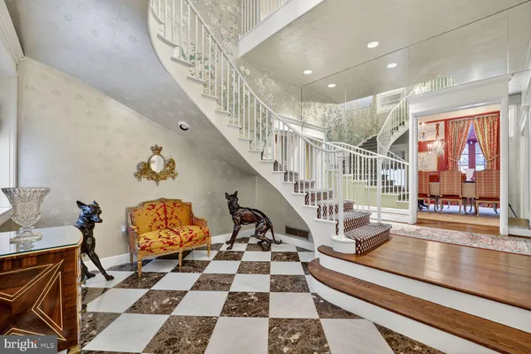 a room with lots of white furniture and a rug