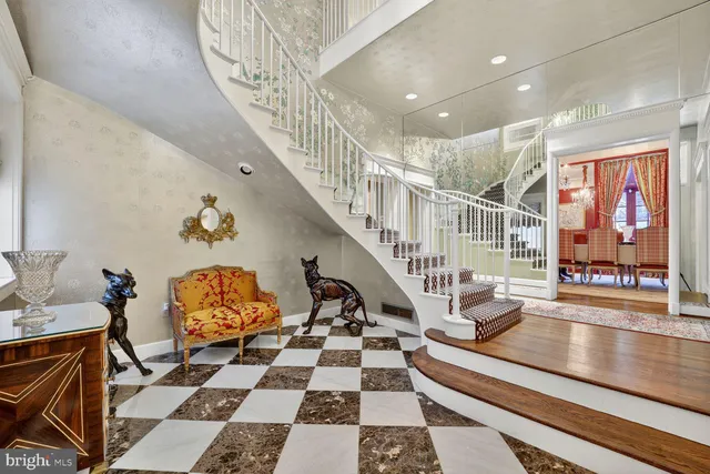 a room with lots of white furniture and a rug