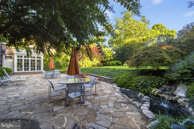 a view of a house with backyard and sitting area