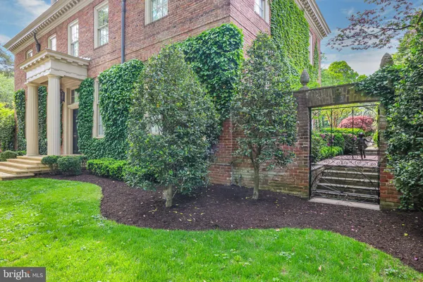 a backyard of a house with plants and outdoor seating