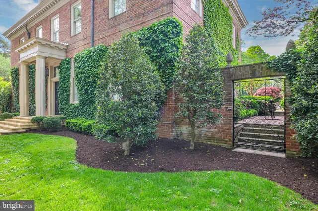 a backyard of a house with plants and outdoor seating