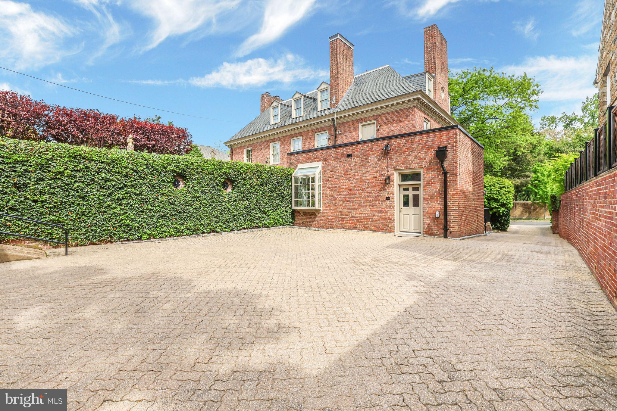 2310 Kalorama Road Northwest Washington, DC 20008 - Photo 45 of 50 a front view of a house with a yard and garage