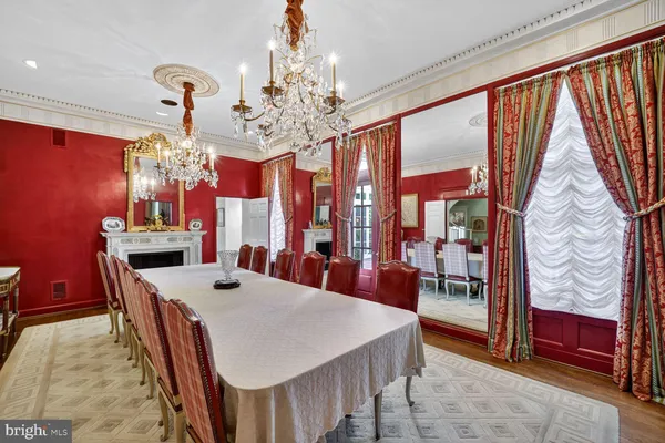 a view of a dining room with furniture a chandelier and window