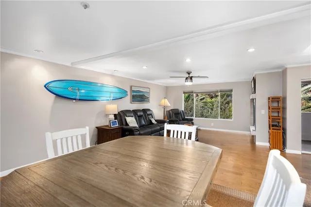 a dining room with furniture and wooden floor