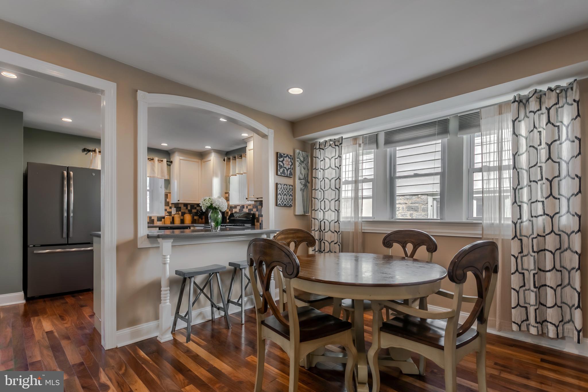34 Greenhill Road Springfield, PA 19064 - Photo 13 of 36 a kitchen with a dining table chairs and refrigerator