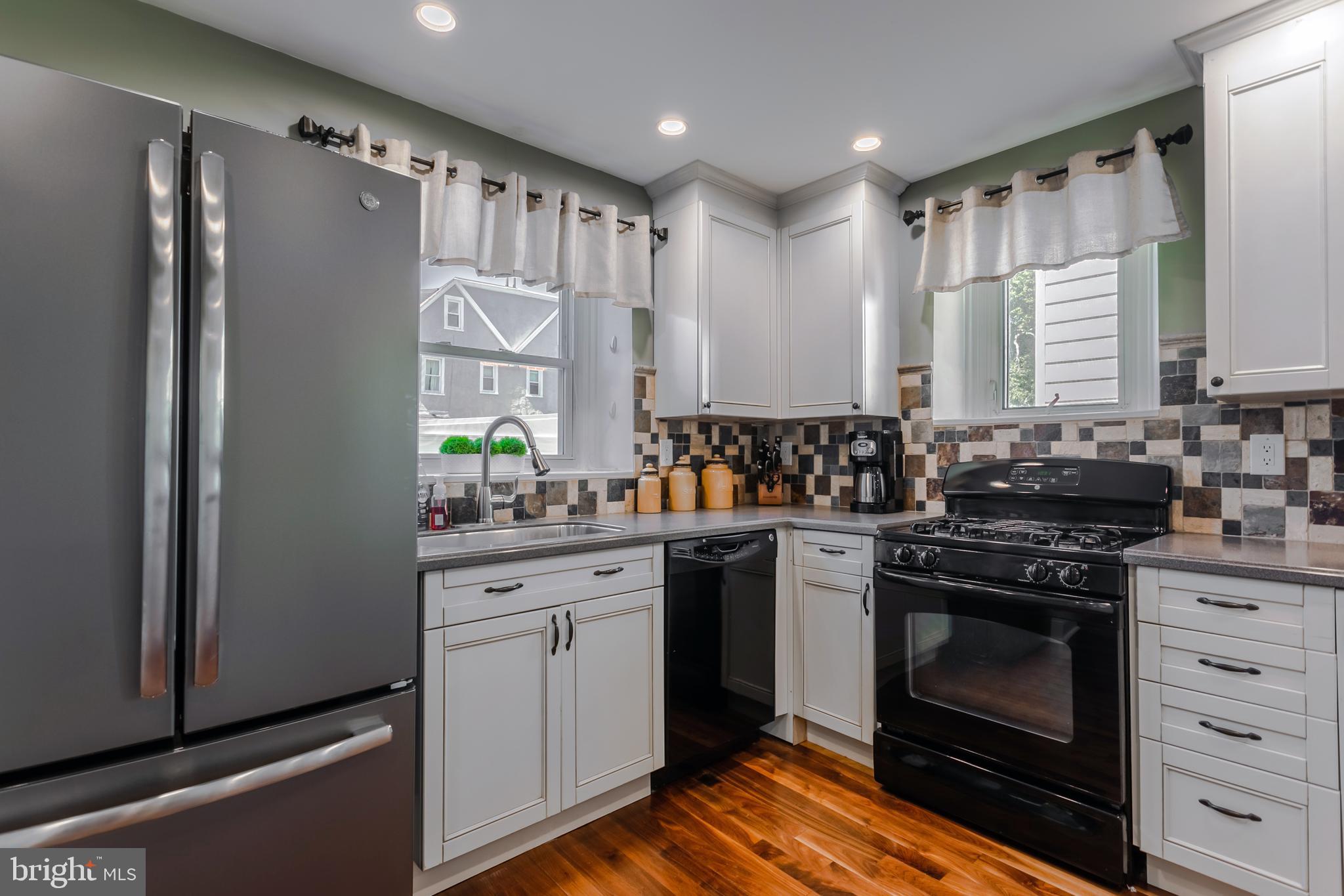 34 Greenhill Road Springfield, PA 19064 - Photo 14 of 36 a kitchen with stainless steel appliances a stove a sink and a refrigerator