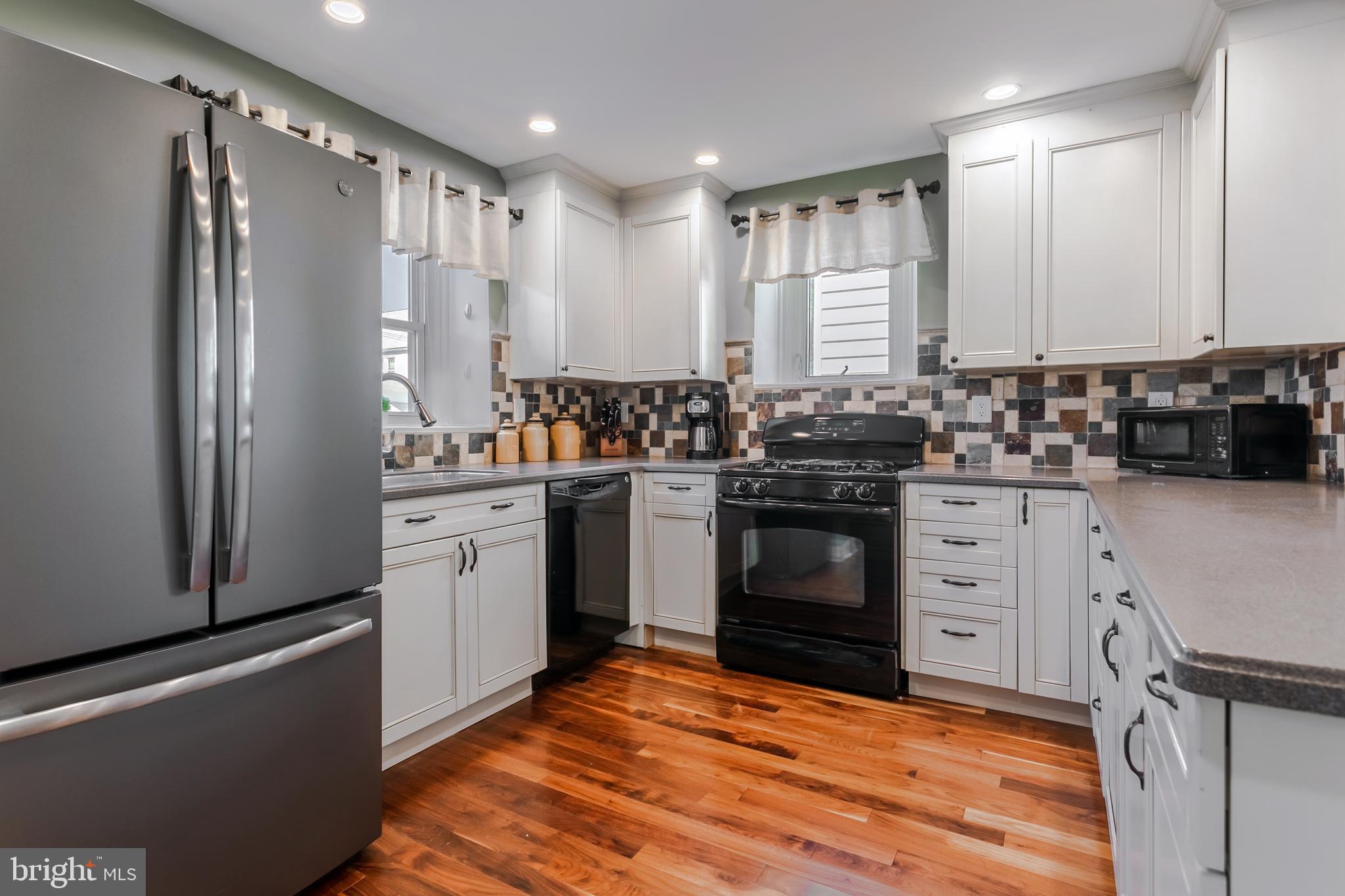 34 Greenhill Road Springfield, PA 19064 - Photo 17 of 36 a kitchen with a sink stove and refrigerator