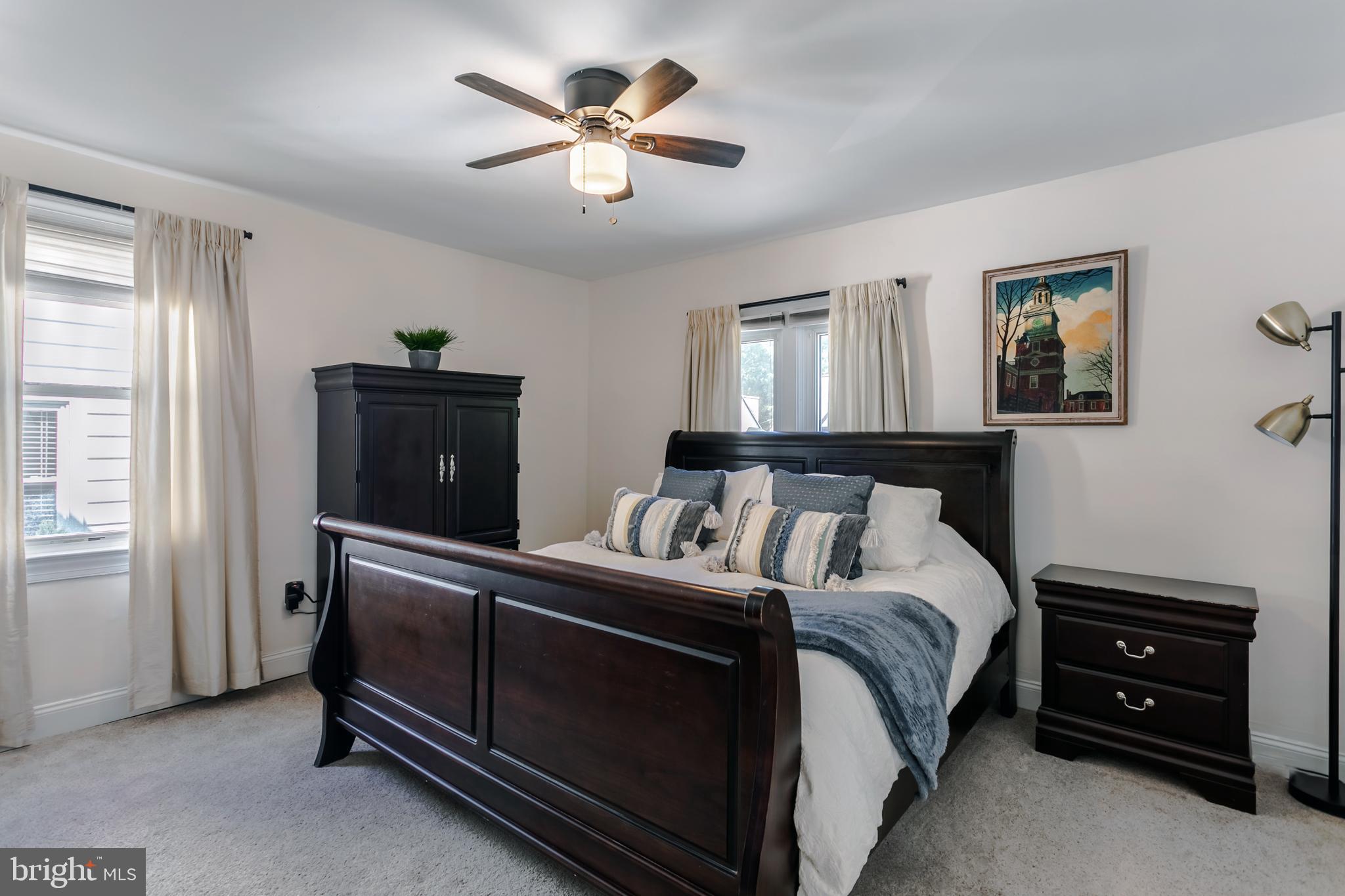 34 Greenhill Road Springfield, PA 19064 - Photo 19 of 36 a bedroom with a bed and a chandelier