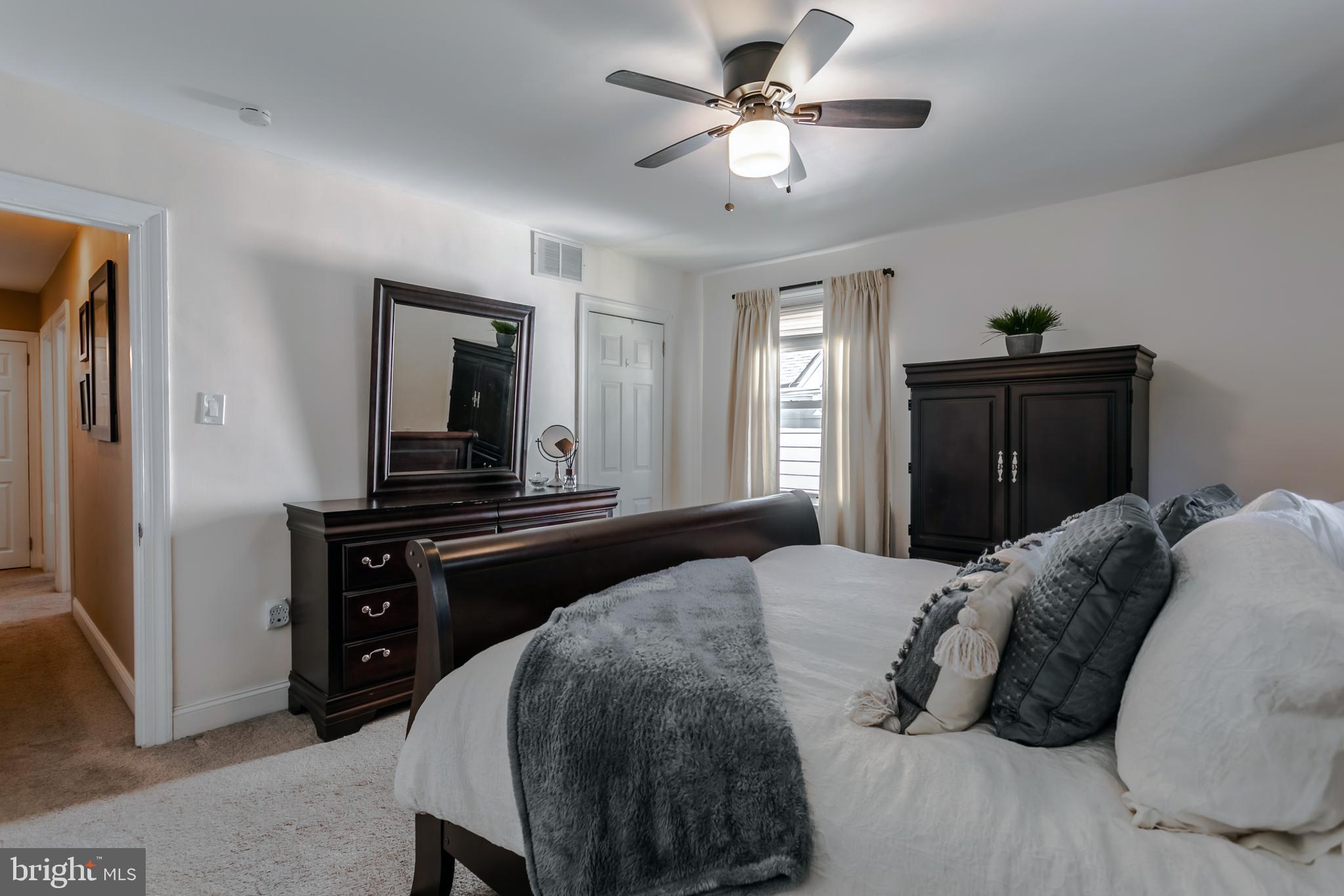 34 Greenhill Road Springfield, PA 19064 - Photo 21 of 36 a bedroom with a bed and a chandelier