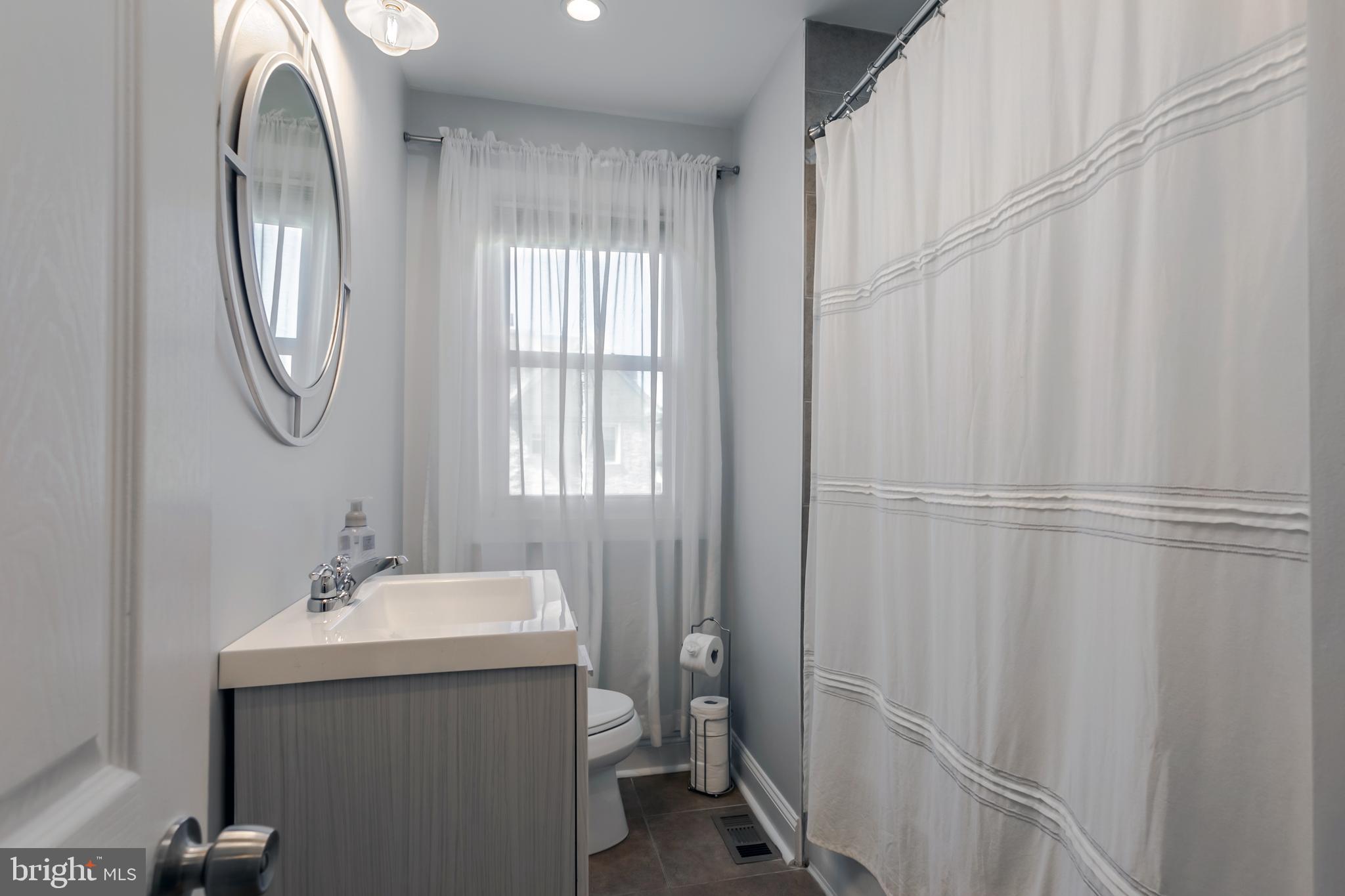 34 Greenhill Road Springfield, PA 19064 - Photo 26 of 36 a bathroom with a sink and a mirror
