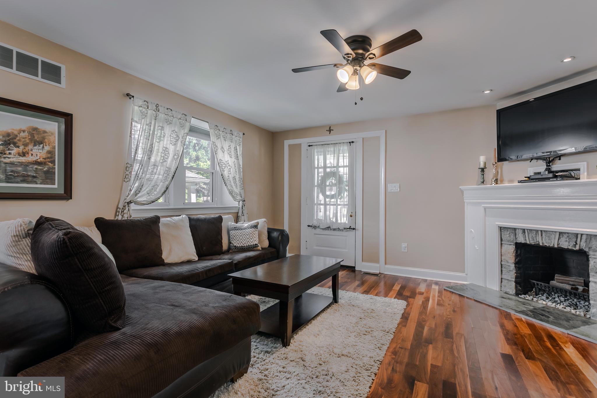34 Greenhill Road Springfield, PA 19064 - Photo 8 of 36 a living room with furniture a fireplace and a flat screen tv