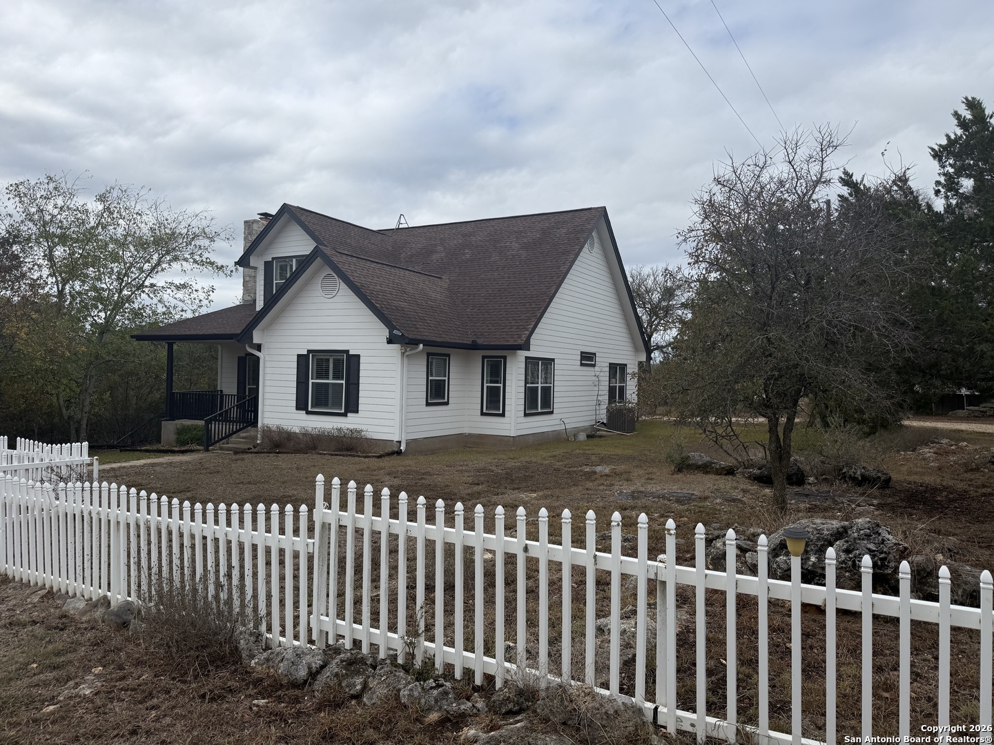 888 Burnett Ranch Road Wimberley, TX 78676 - Photo 1 of 1 a front view of a house with a garden