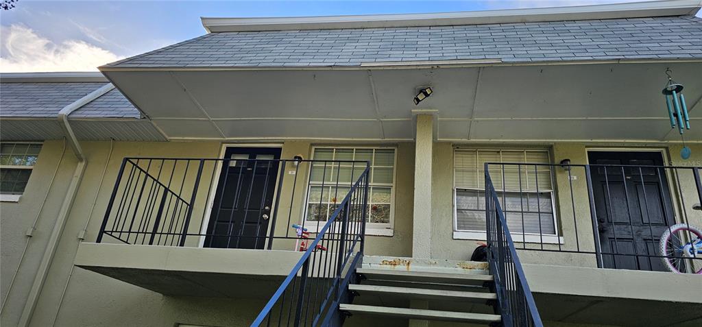 525 South Conway Road, Unit 31 Orlando, FL 32807 - Photo 3 of 5 a view of a balcony with wooden floor and stairs