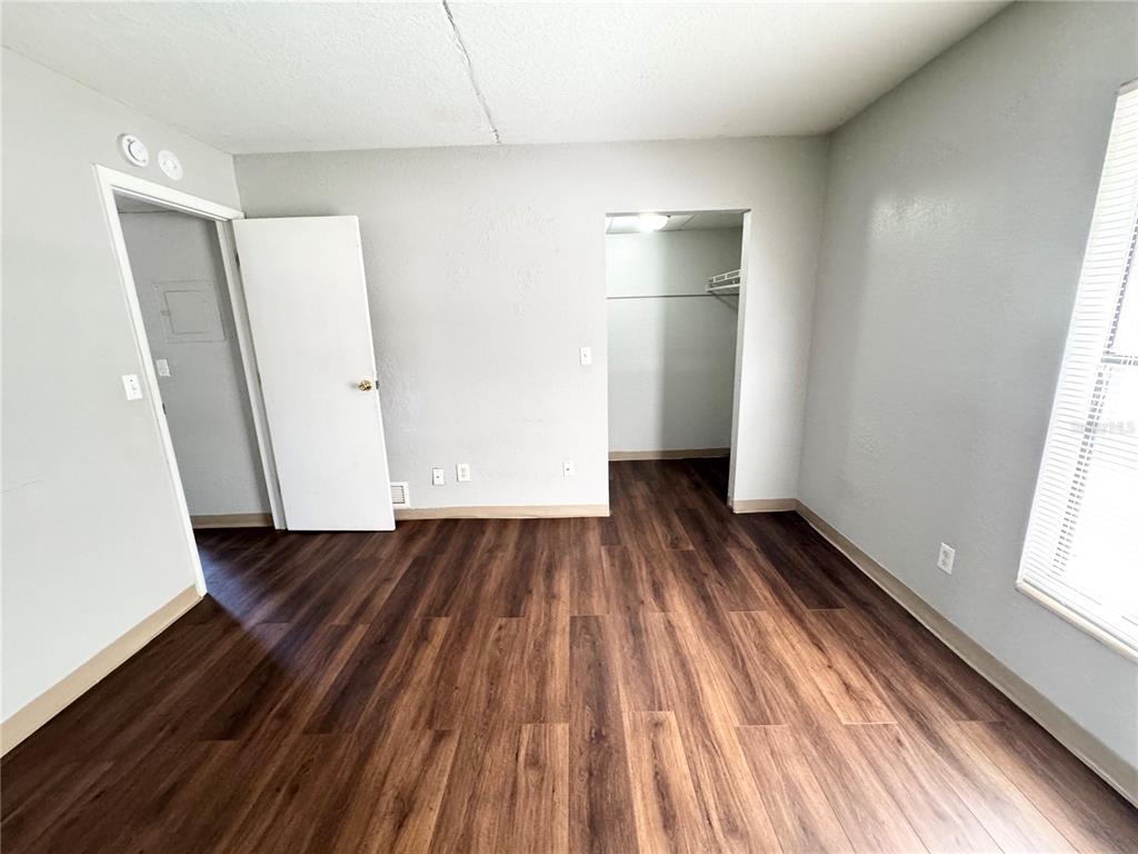 1229 Kennedy Road, Unit 69 Daytona Beach, FL 32117 - Photo 14 of 16 a view of a room with wooden floor and window