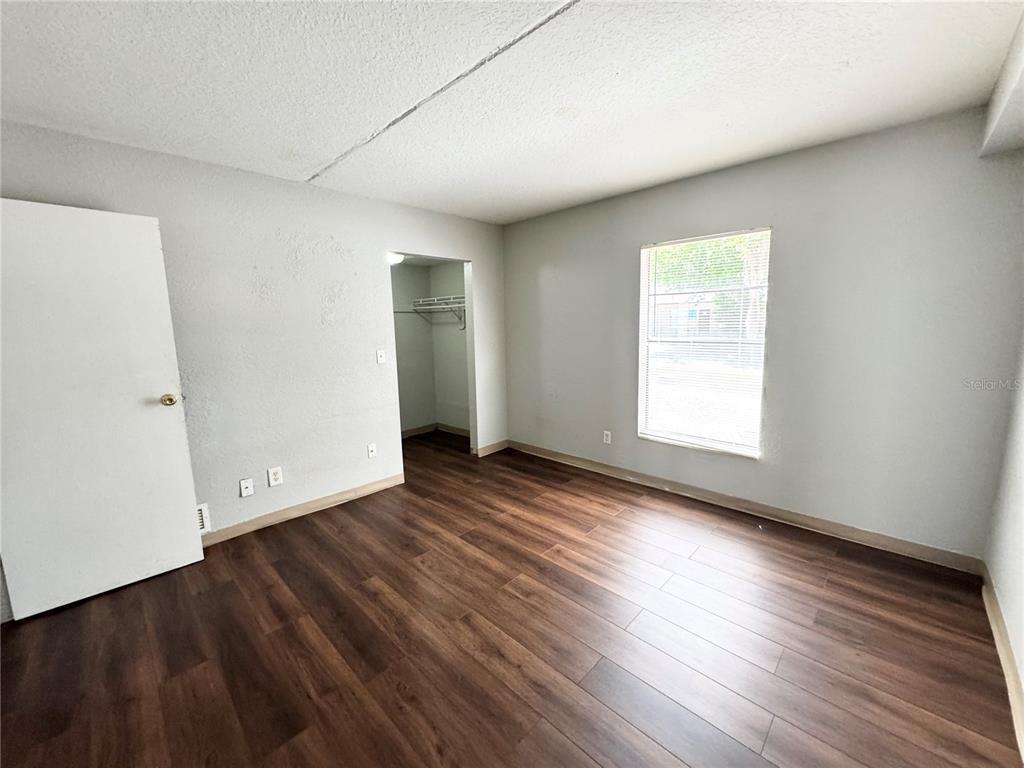 1229 Kennedy Road, Unit 69 Daytona Beach, FL 32117 - Photo 15 of 16 an empty room with wooden floor and windows
