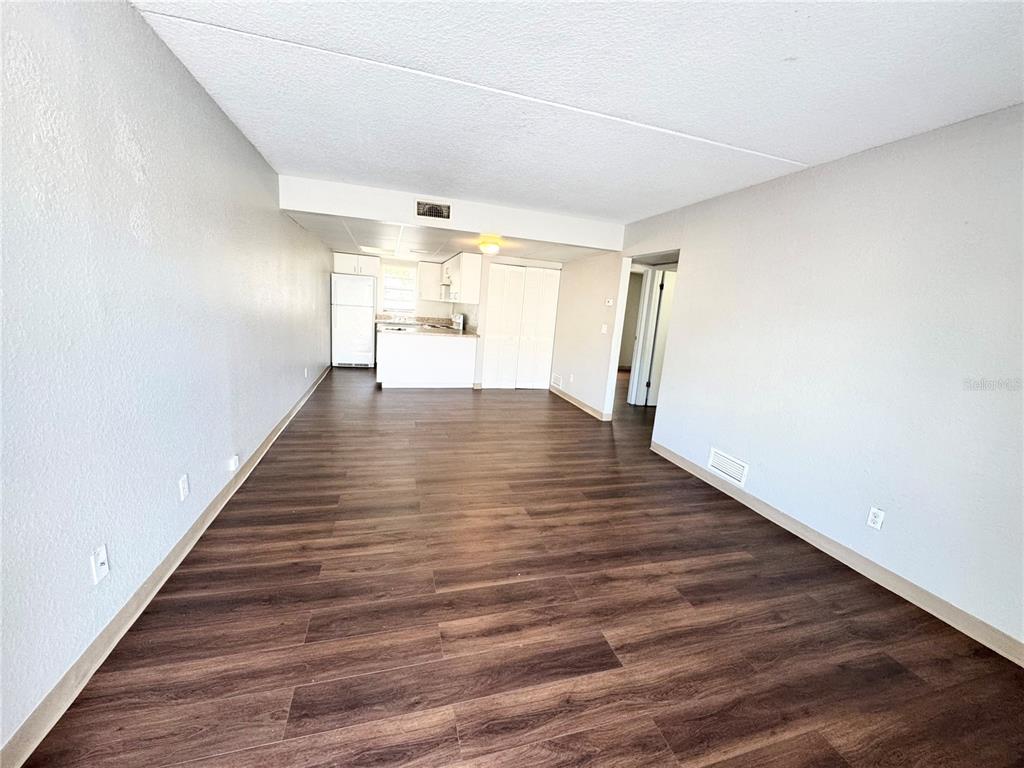 1229 Kennedy Road, Unit 69 Daytona Beach, FL 32117 - Photo 2 of 16 a view of empty room with wooden floor