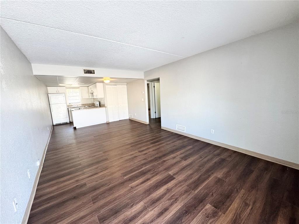 1229 Kennedy Road, Unit 69 Daytona Beach, FL 32117 - Photo 3 of 16 a view of empty room with wooden floor