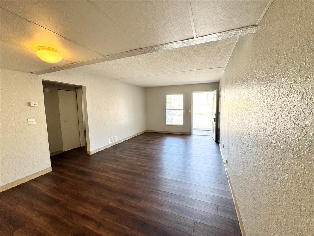 1229 Kennedy Road, Unit 69 Daytona Beach, FL 32117 - Photo 4 of 16 a view of a room with wooden floor and window