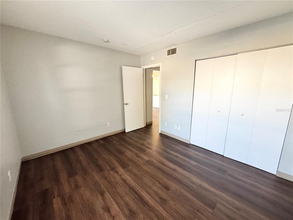 1229 Kennedy Road, Unit 69 Daytona Beach, FL 32117 - Photo 8 of 16 a view of an empty room with wooden floor