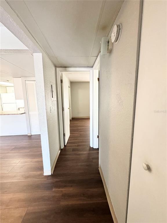 1229 Kennedy Road, Unit 69 Daytona Beach, FL 32117 - Photo 10 of 16 a view of a hallway with wooden floor