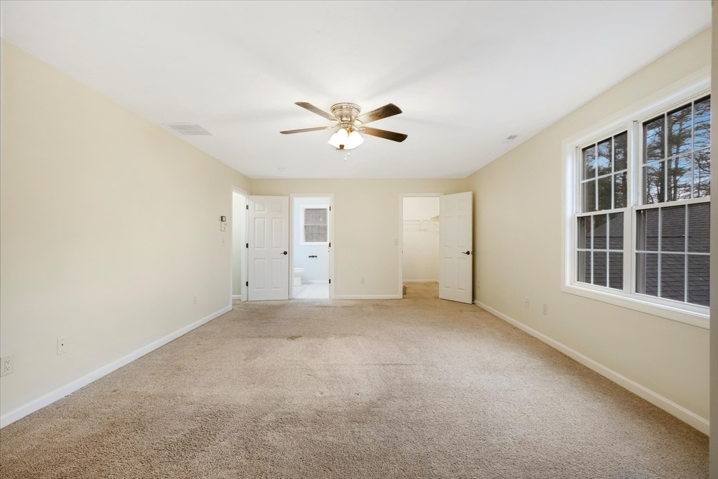 269 Tispaquin Street Middleboro, MA 02346 - Photo 13 of 40 an empty room with chandelier fan and windows