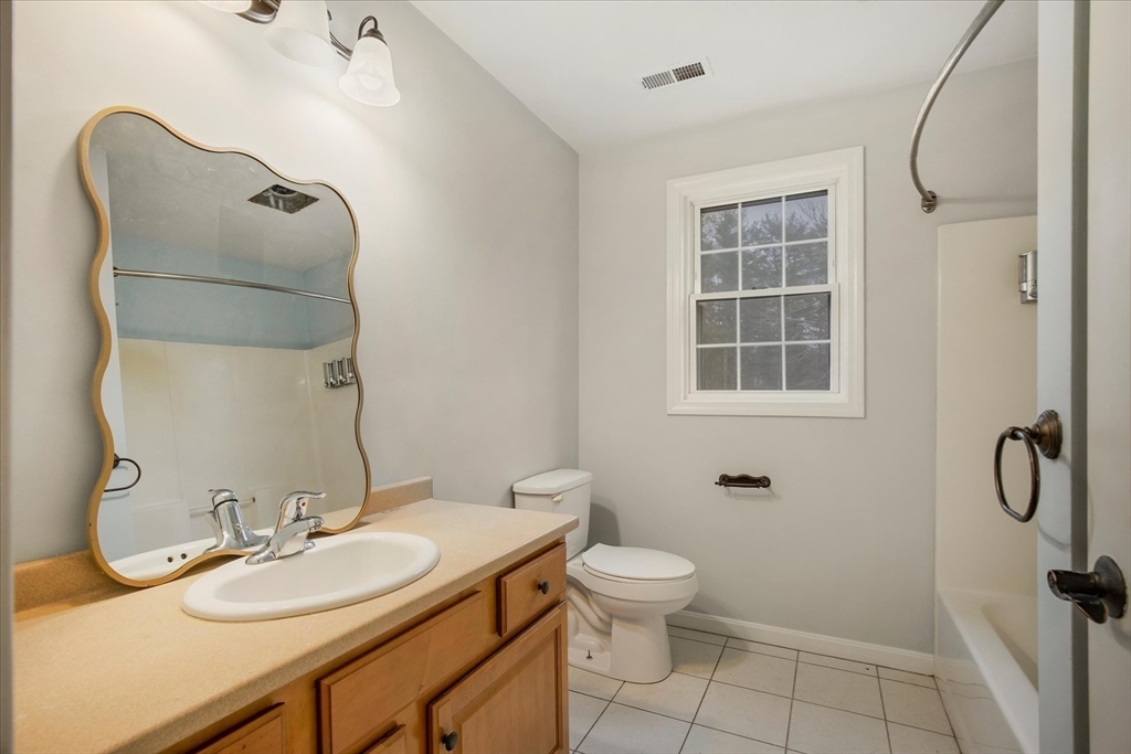 269 Tispaquin Street Middleboro, MA 02346 - Photo 16 of 40 a bathroom with a granite countertop sink toilet and shower