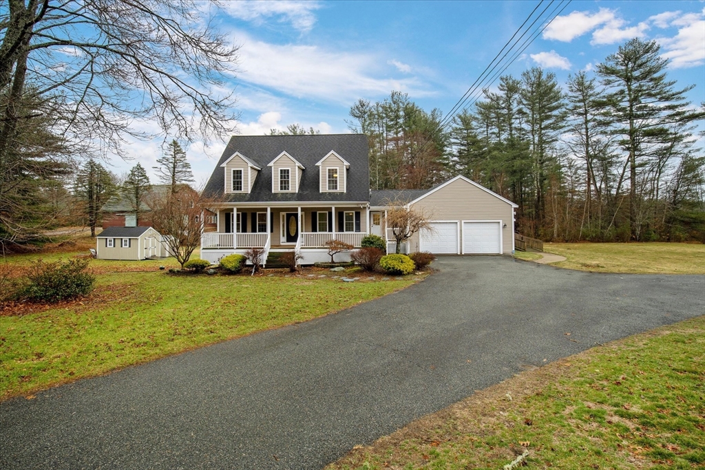 269 Tispaquin Street Middleboro, MA 02346 - Photo 2 of 40 a front view of a house with a yard and garage