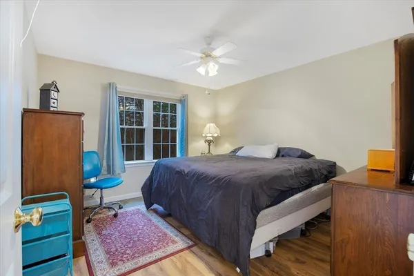 a bedroom with a bed and a window