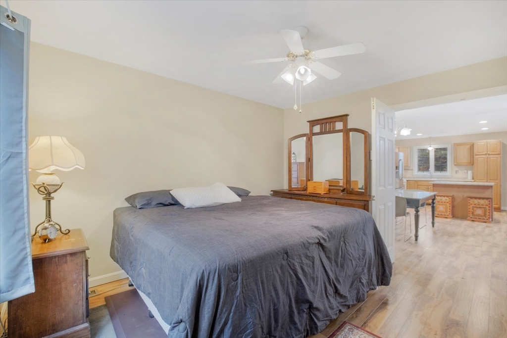 269 Tispaquin Street Middleboro, MA 02346 - Photo 27 of 40 a bedroom with a bed and a chandelier