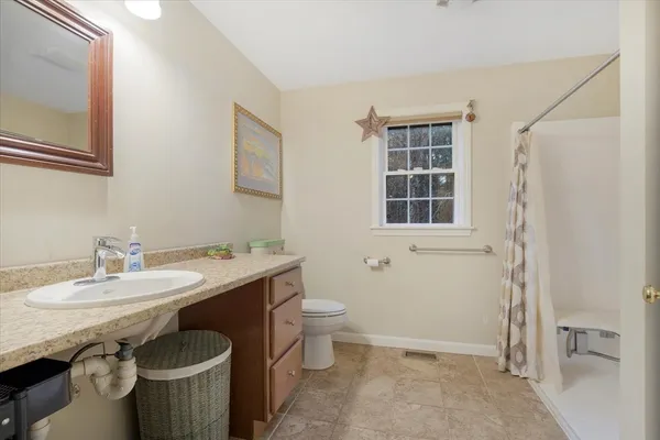 a bathroom with a sink toilet and shower