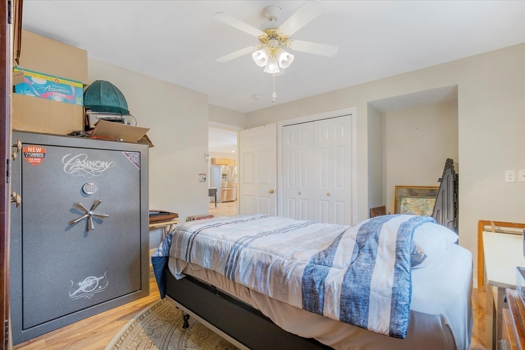 269 Tispaquin Street Middleboro, MA 02346 - Photo 35 of 40 a bedroom with a bed and a chandelier