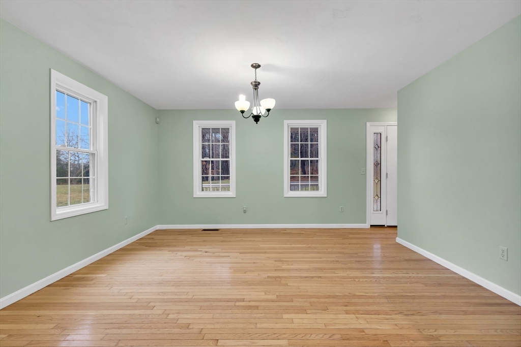 269 Tispaquin Street Middleboro, MA 02346 - Photo 6 of 40 a view of an empty room with wooden floor and a window