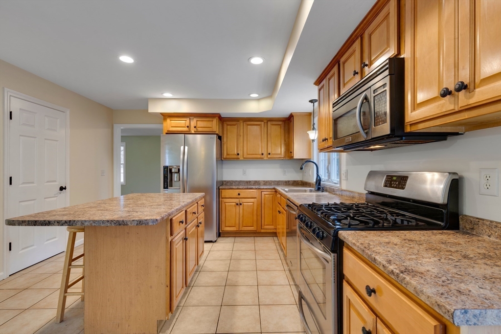 269 Tispaquin Street Middleboro, MA 02346 - Photo 9 of 40 a kitchen with stainless steel appliances granite countertop a stove and a sink