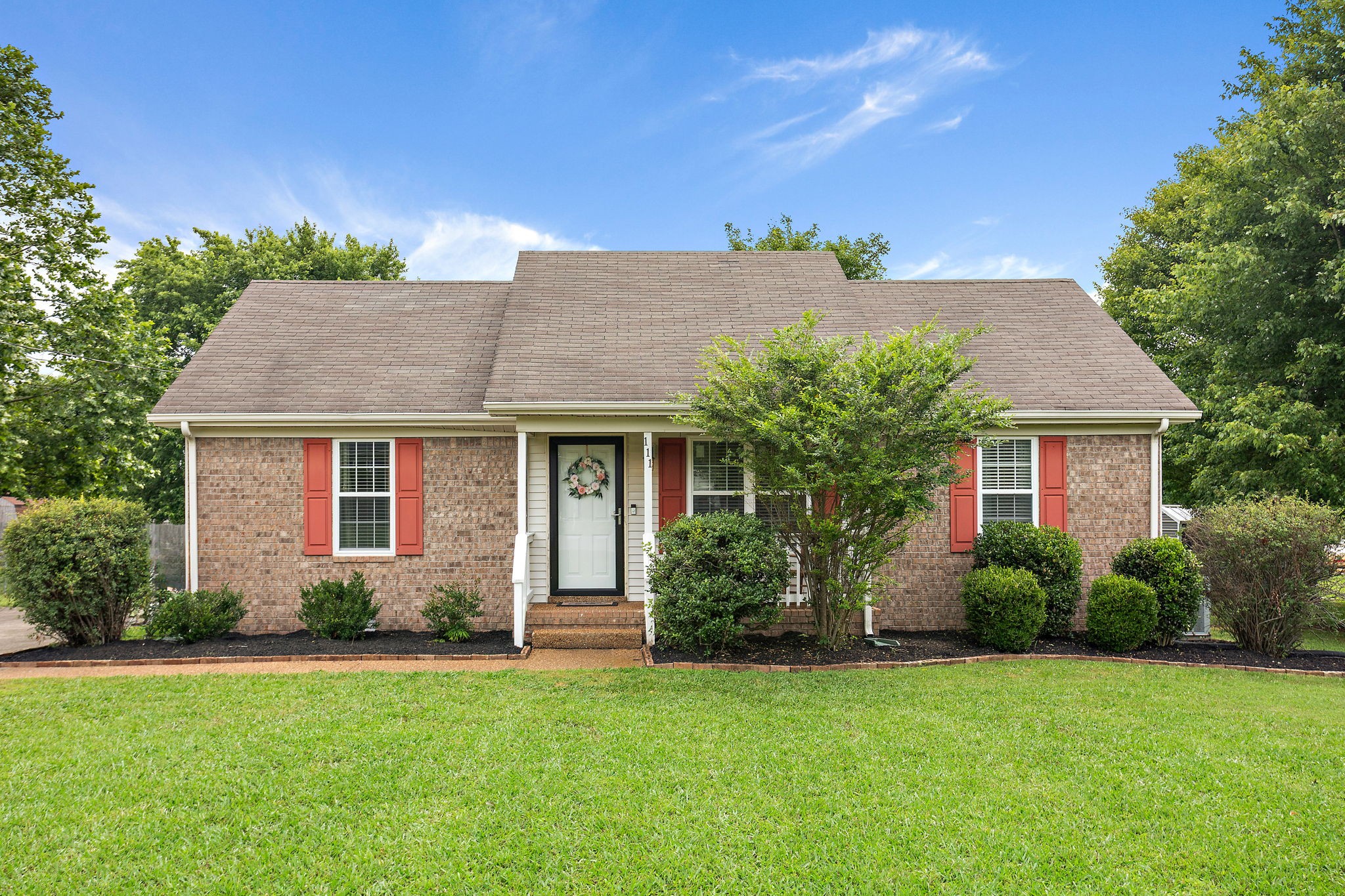a front view of a house with garden