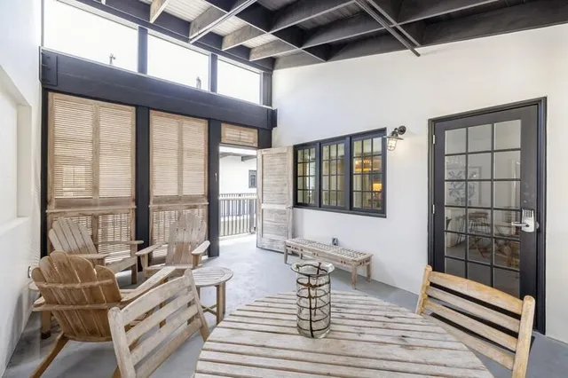 a work room with glass windows and furniture