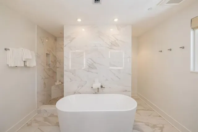 a white bath tub sitting in a bathroom