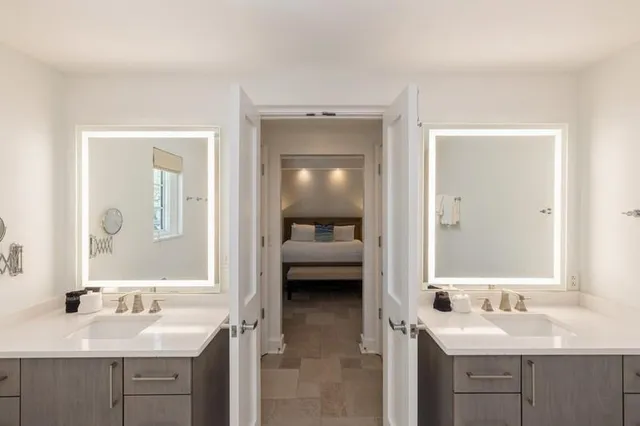 a en suite bathroom with a sink a mirror and a shower