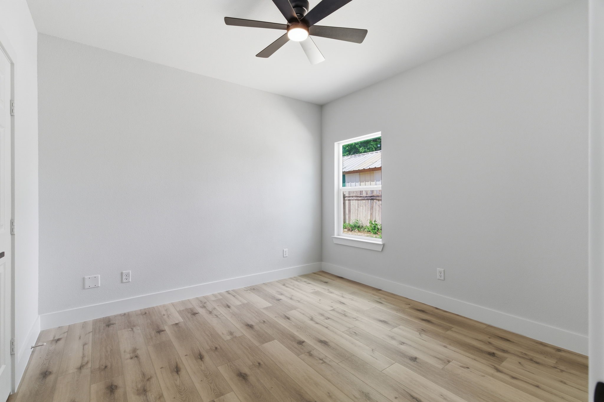 7040 Kinney Street Houston, TX 77087 - Photo 23 of 47 wooden floor in an empty room with a window