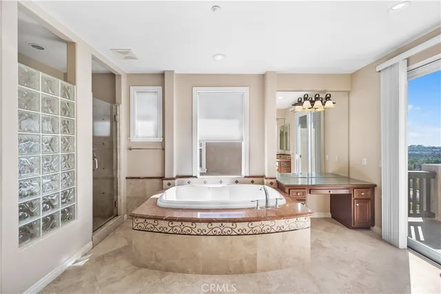 a spacious bathroom with a tub and large windows