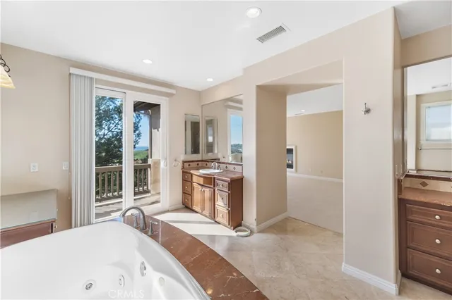 a large bedroom with a large bed and a large window