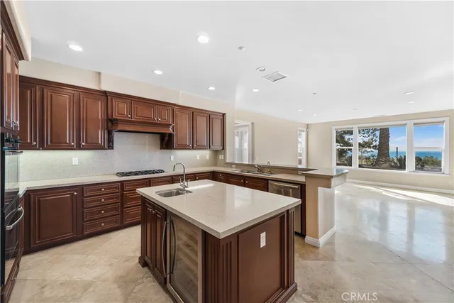 a kitchen with a stove sink and cabinets