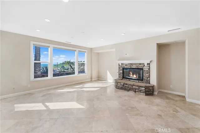 a view of an empty room with furniture and a fireplace