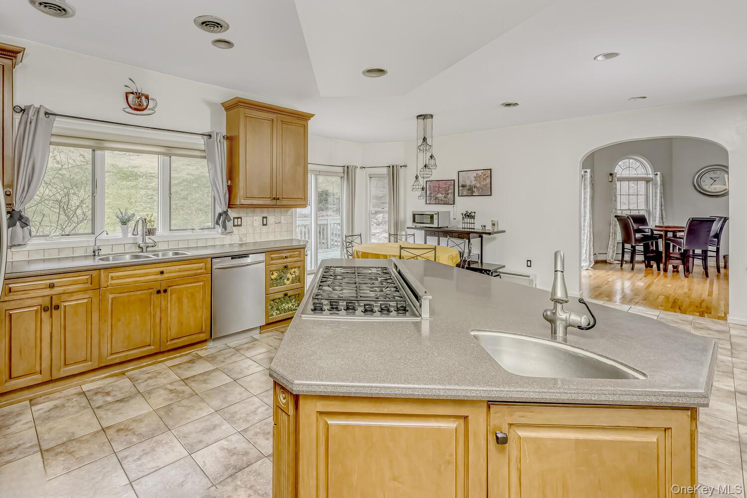 22 Golden Road Suffern, NY 10901 - Photo 18 of 41 Kitchen with decorative backsplash, light tile patterned floors, appliances with stainless steel finishes, a center island, and recessed lighting