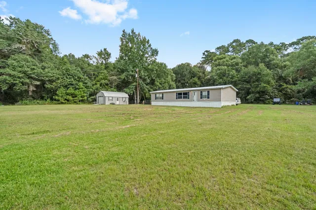 a view of a large pool with an outdoor space and seating area